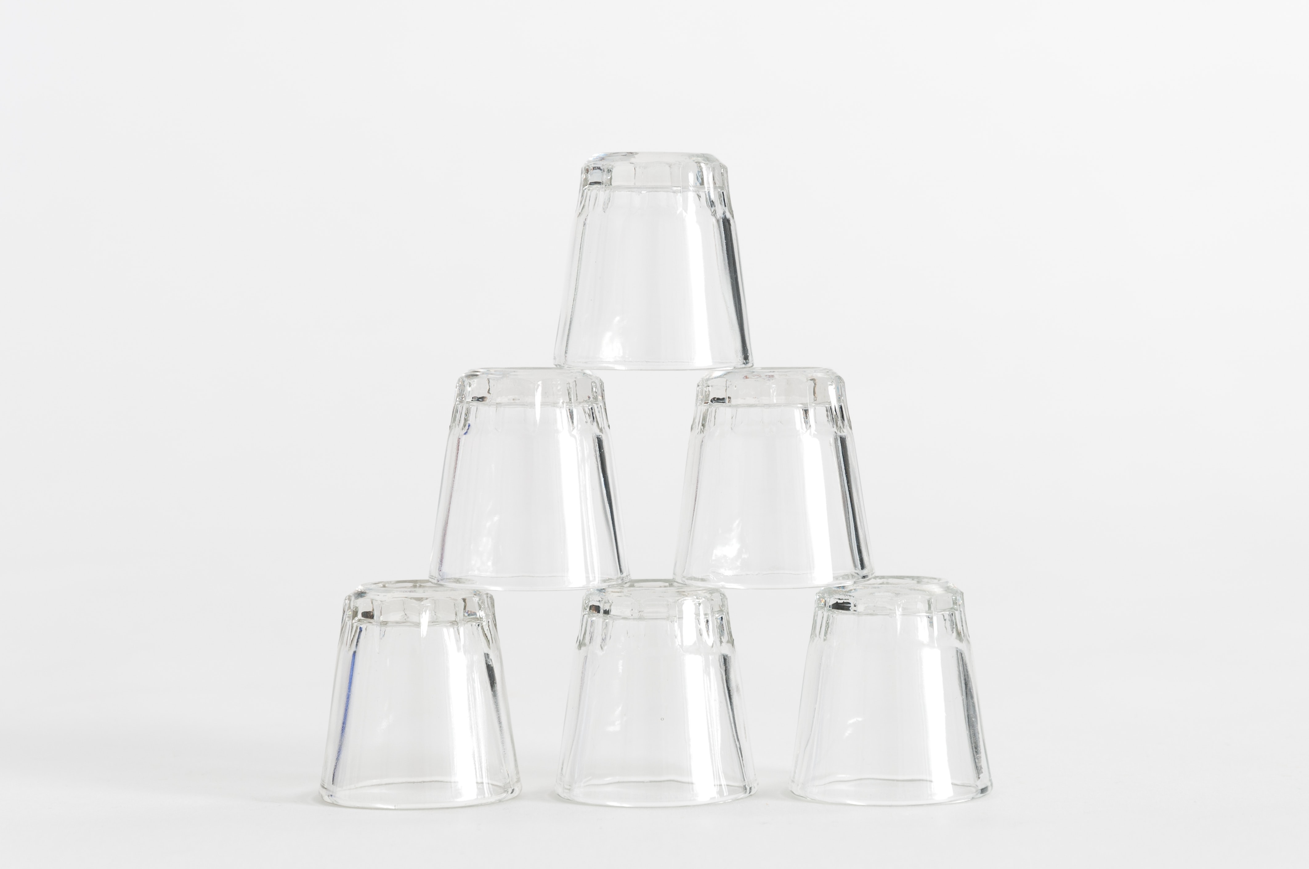 Six glasses in a pyramid to show the concept of clear design