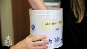 Hand drawing bill from parliamentary biscuit tin
